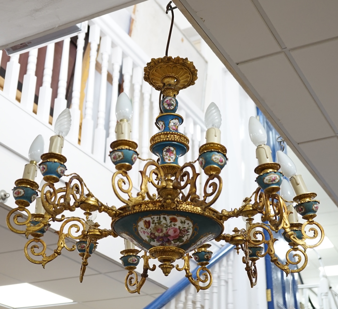 A Sevres style porcelain and gilt metal mounted twelve light chandelier, late 19th / 20th century, 60cm high excluding chain. Condition - fair